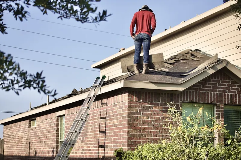 Professional roofer working on a residential roof in Leeds Point